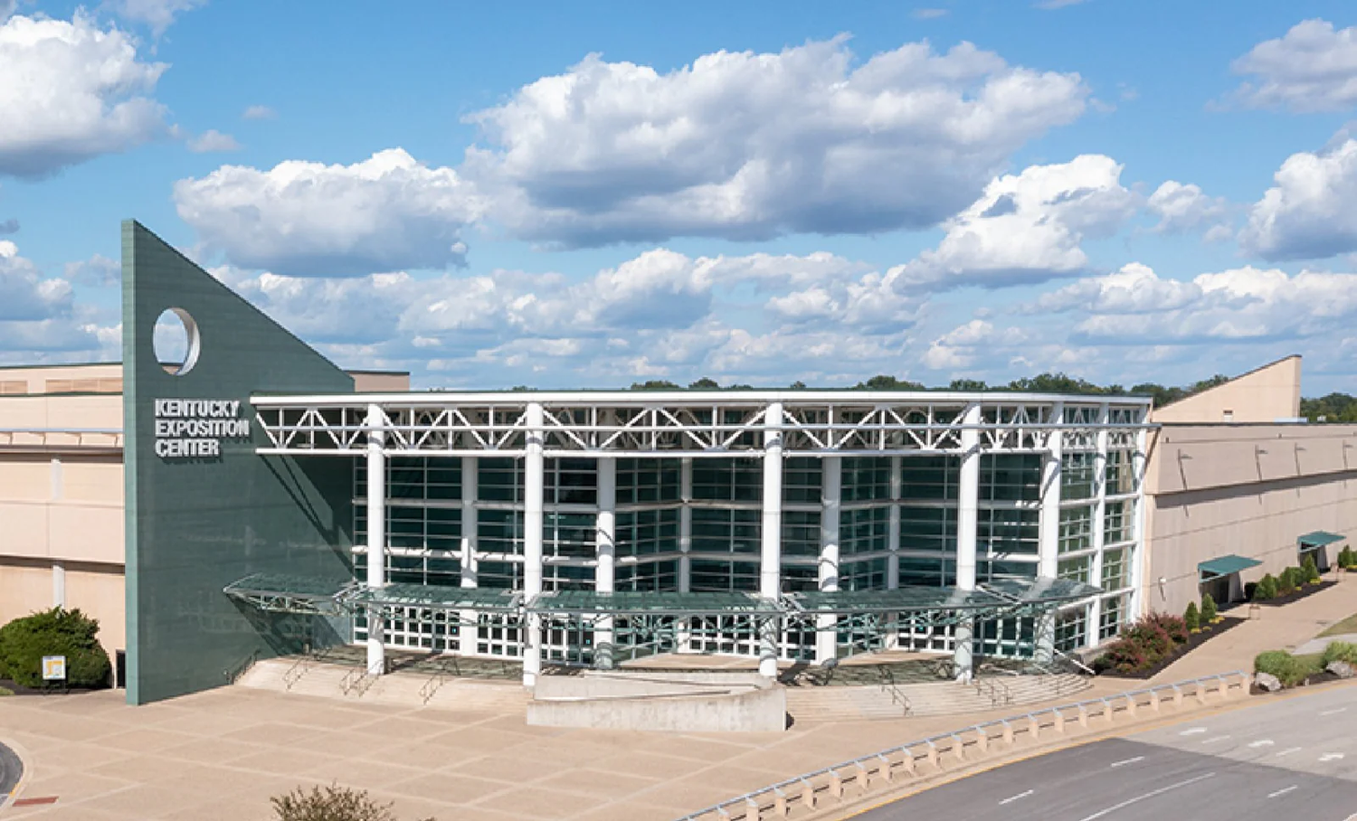 Kentucky Exposition Center building with a blue sky and clouds in the background