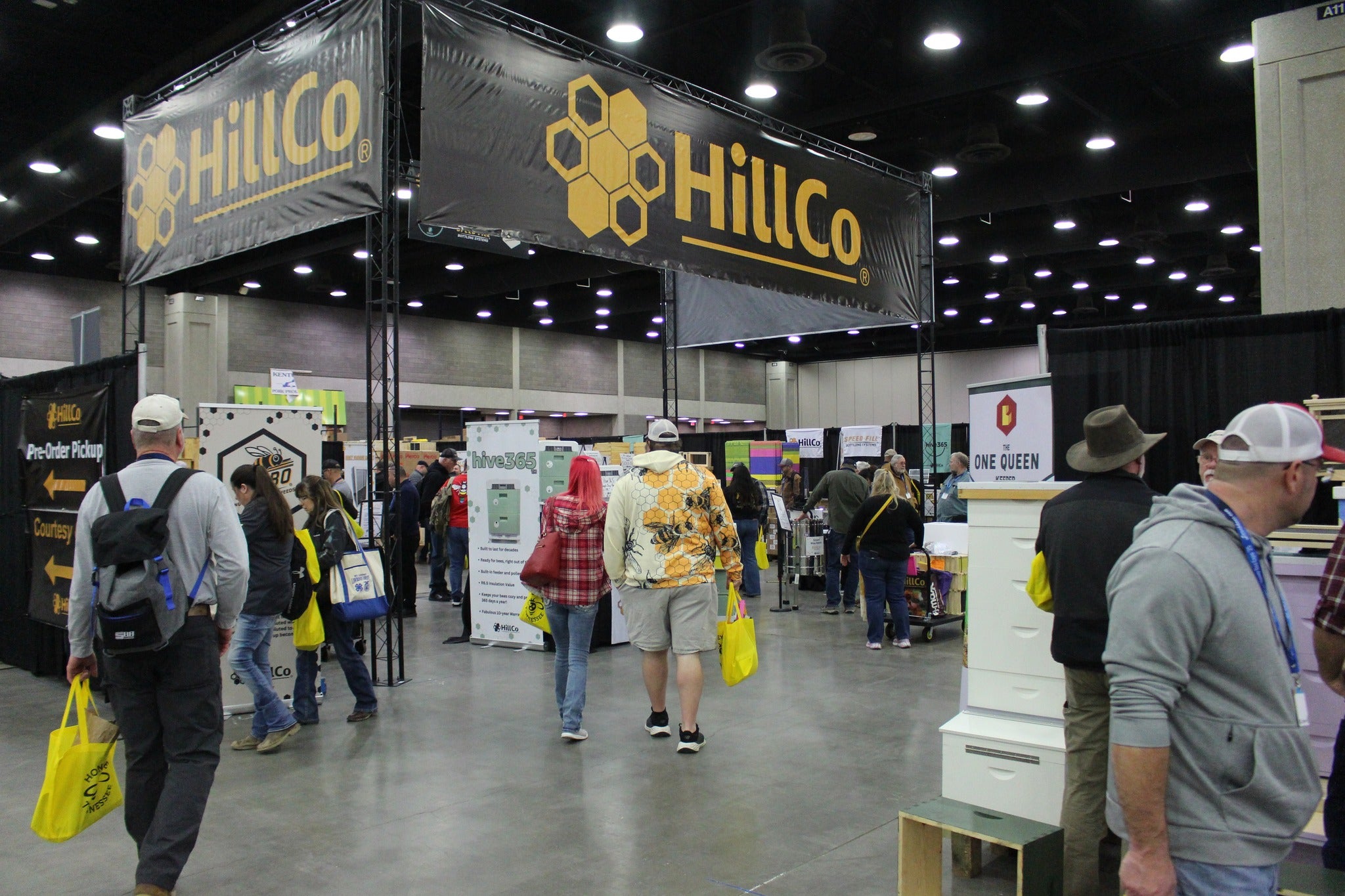 HillCo booth at a trade show with people walking around